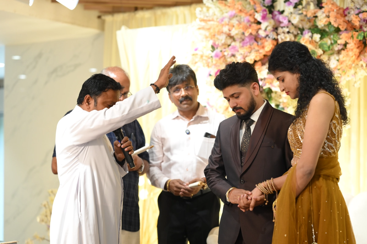 Parish priest blessing the couple during engagement